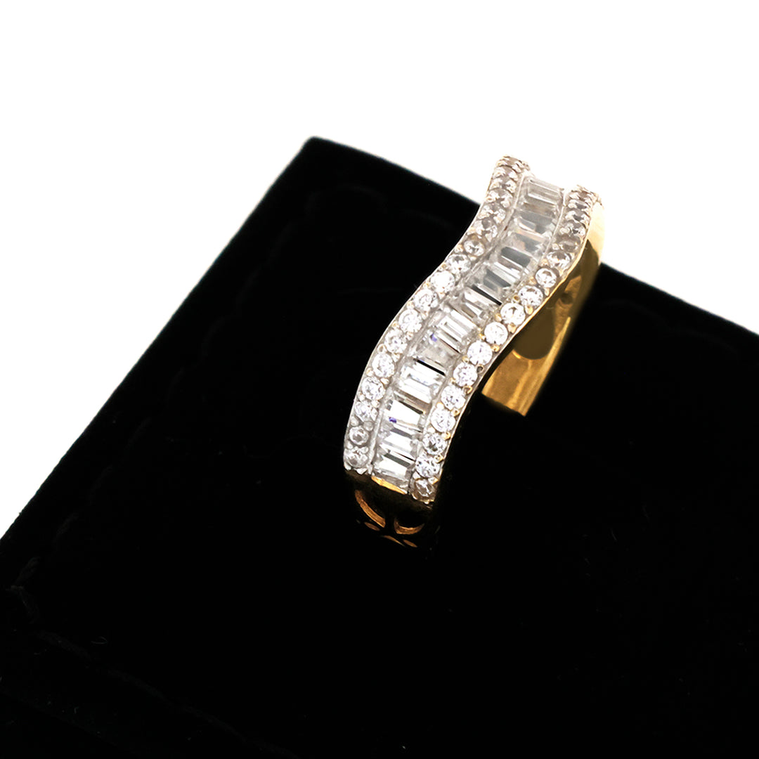 Gold ring with diamond accents on a black cushion