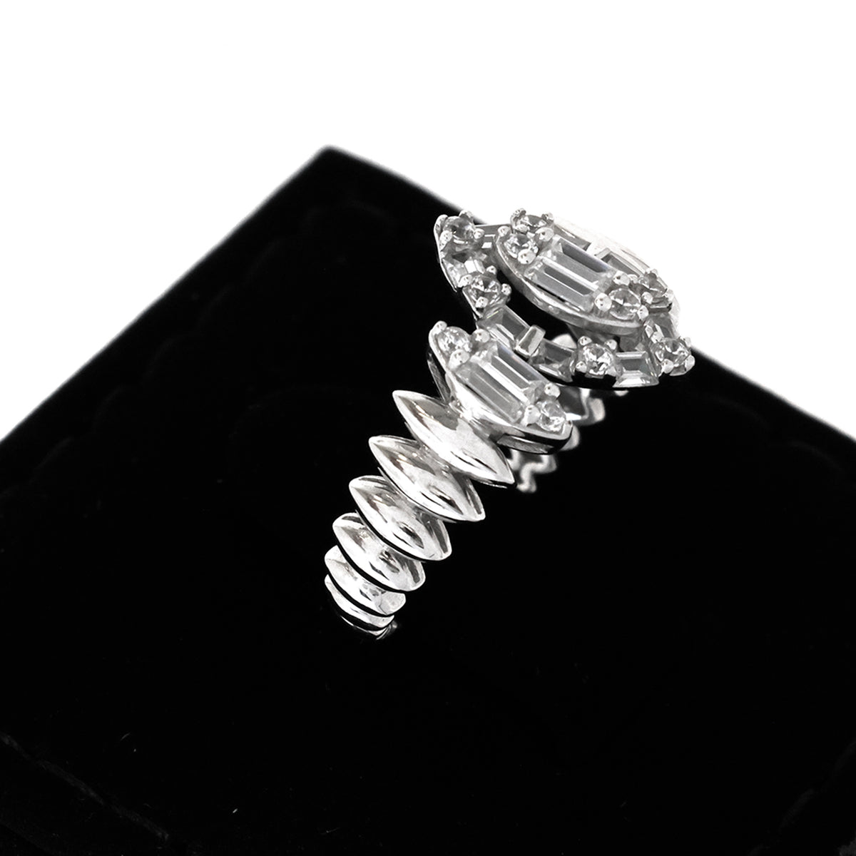 Silver bracelet with clear gemstones on a black background