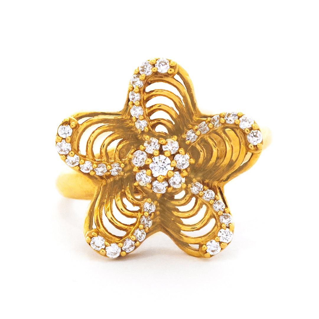 Gold ring with diamond accents on a white background