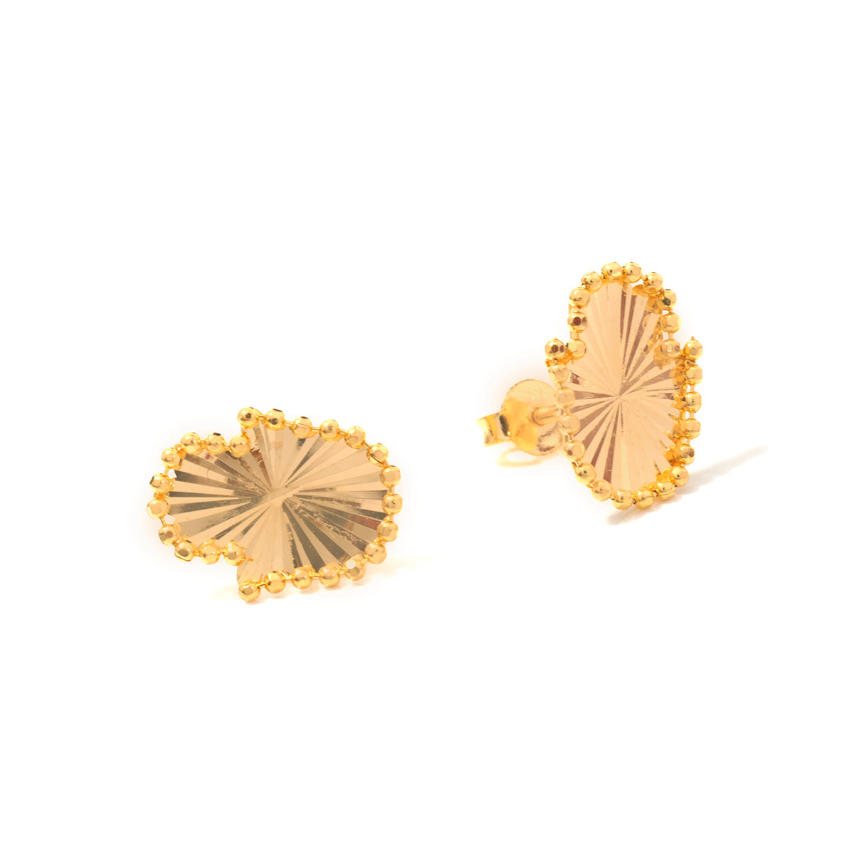 A pair of gold leaf-shaped stud earrings with a textured, sunburst center and a beaded border, shown on a clean white background.