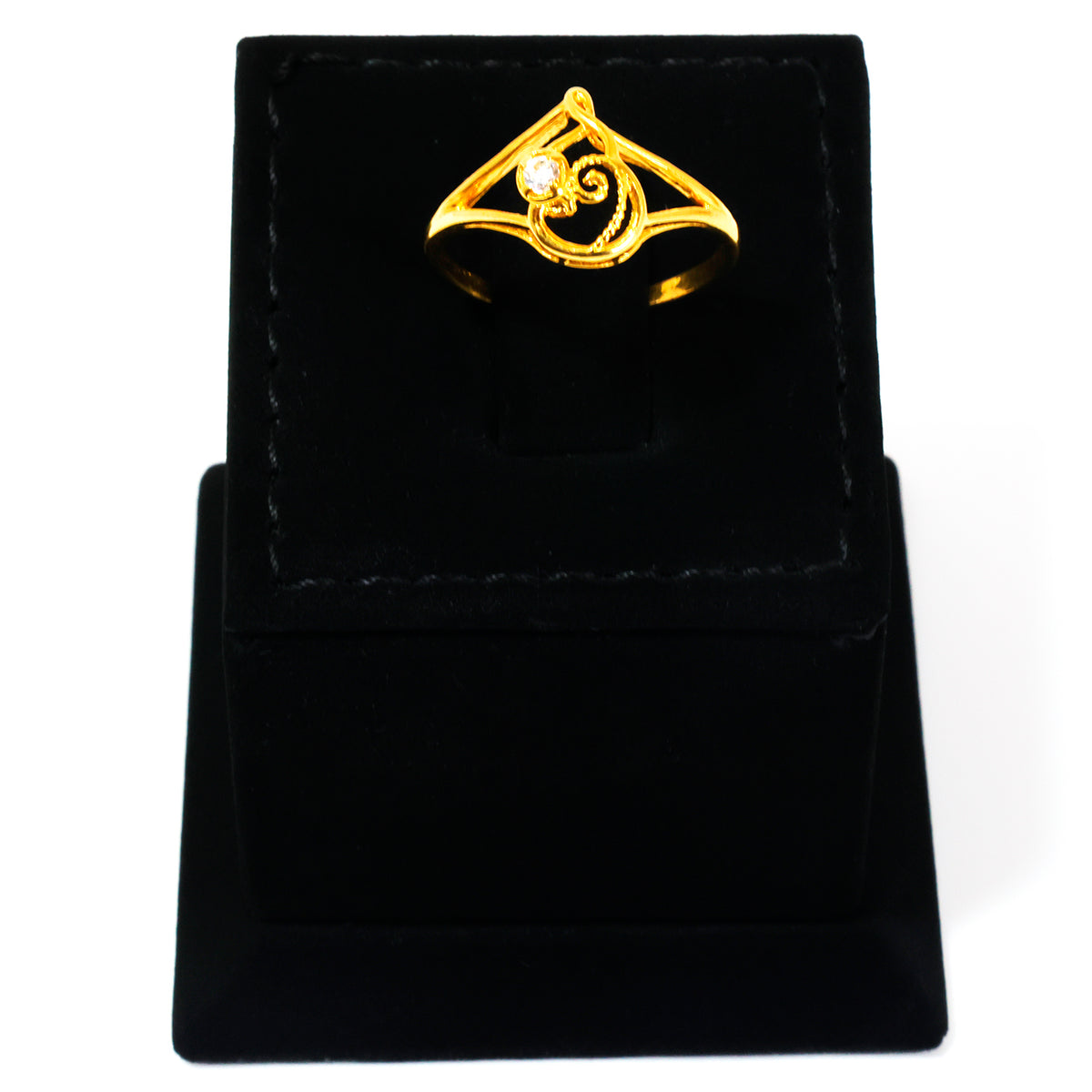 Gold ring with a design on a black velvet stand