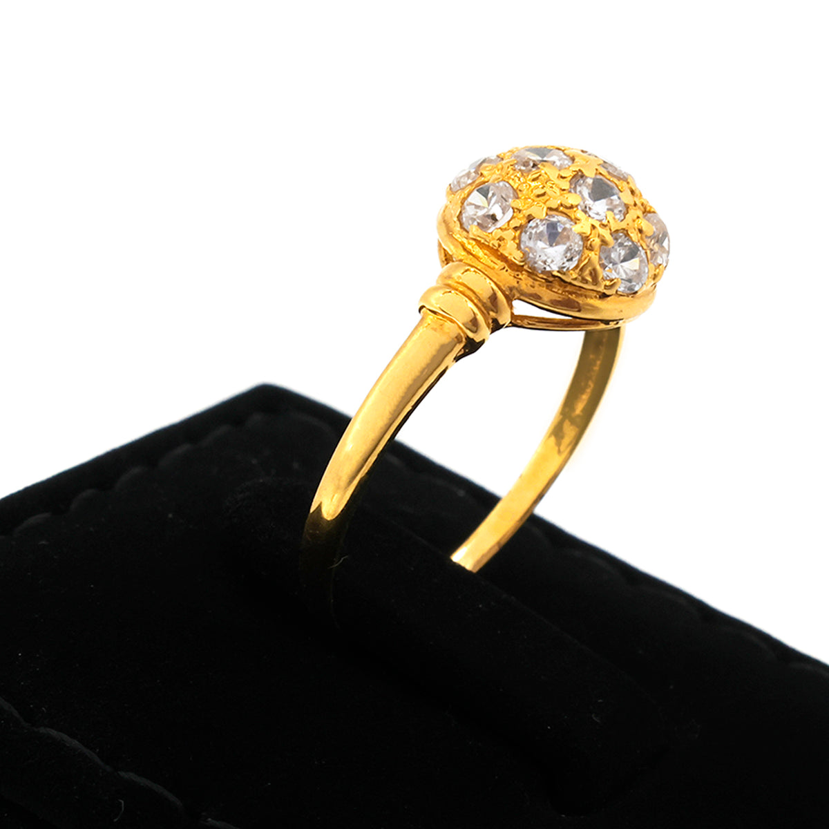 Gold ring with a decorative design on a black cushion
