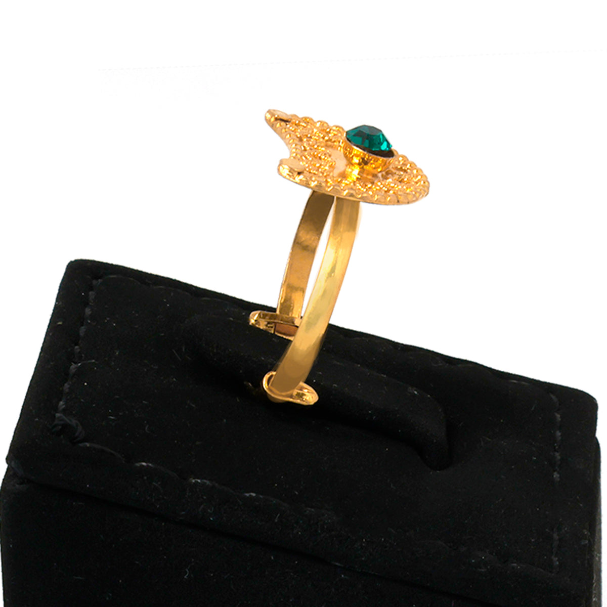 Gold ring with a green gemstone on a black velvet stand