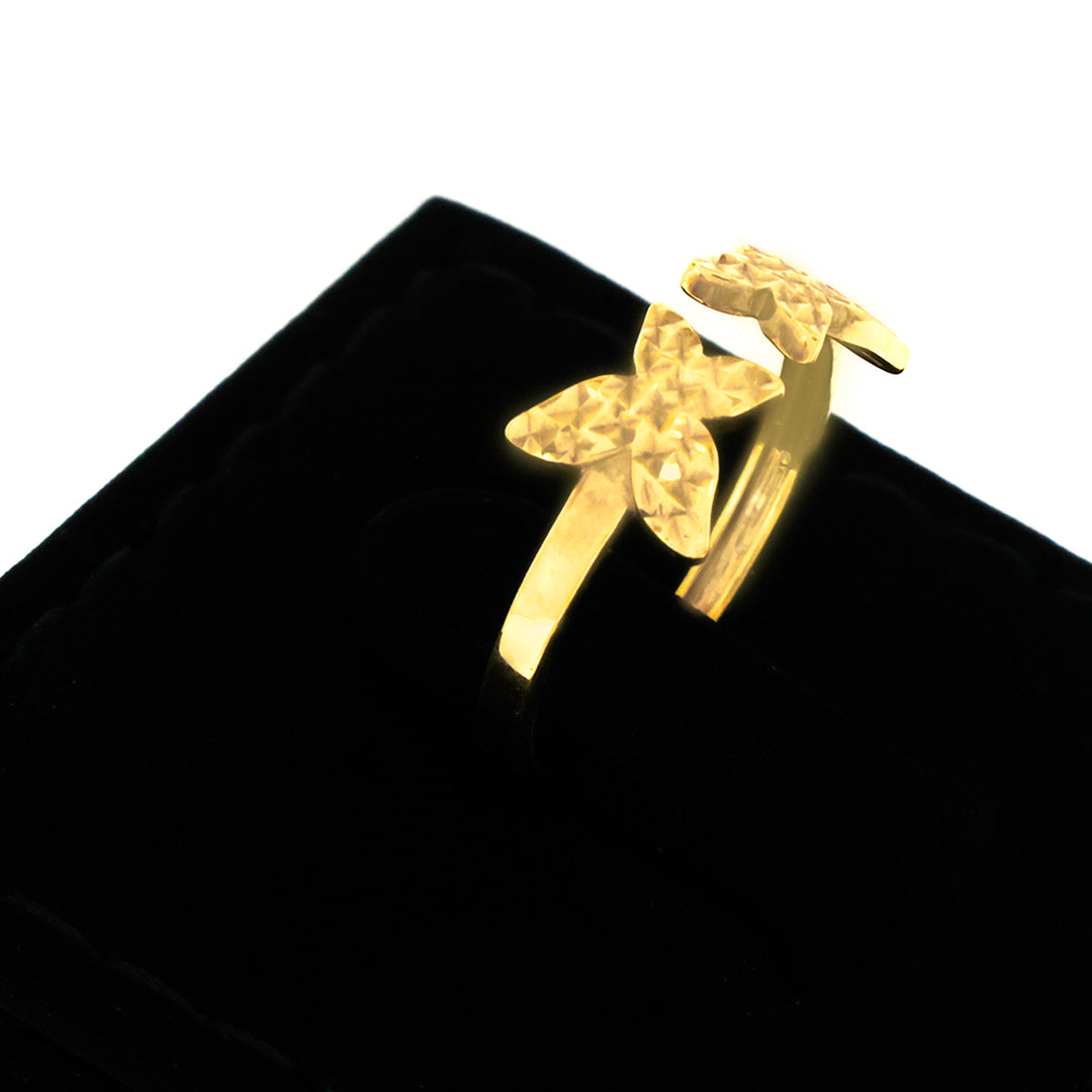 Gold ring with a unique design on a black background
