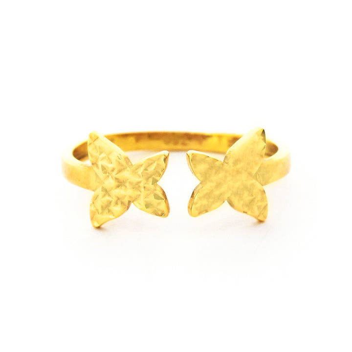 Gold starfish-shaped ring on a white background