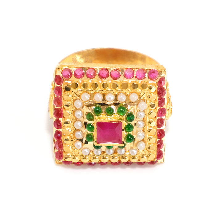 Gold ring with red gemstone and green stones on a white background