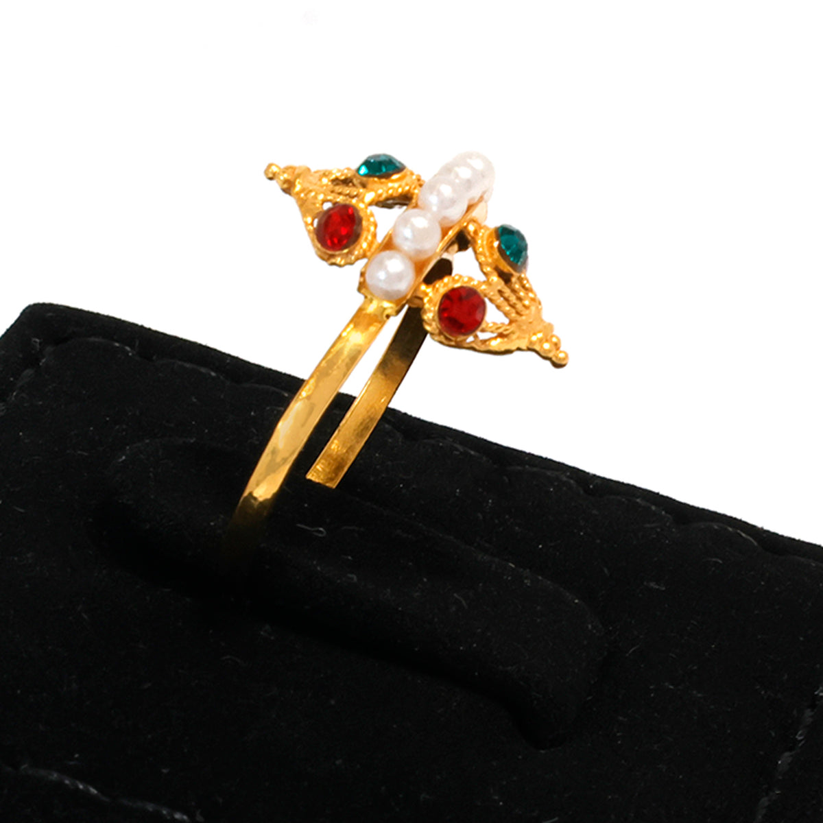 Gold hairpin with pearls and red stones on a black cushion