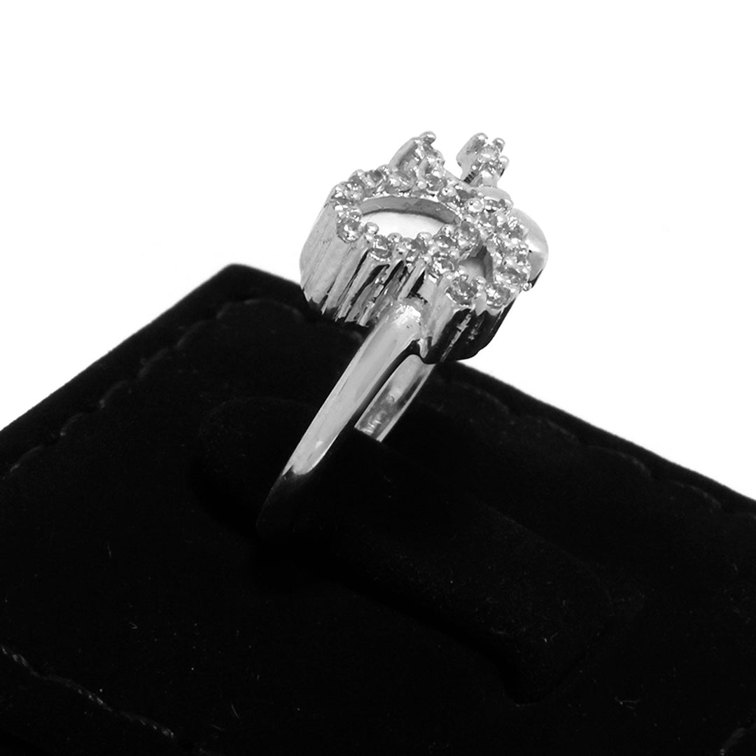 Silver ring with a crown design on a black velvet surface