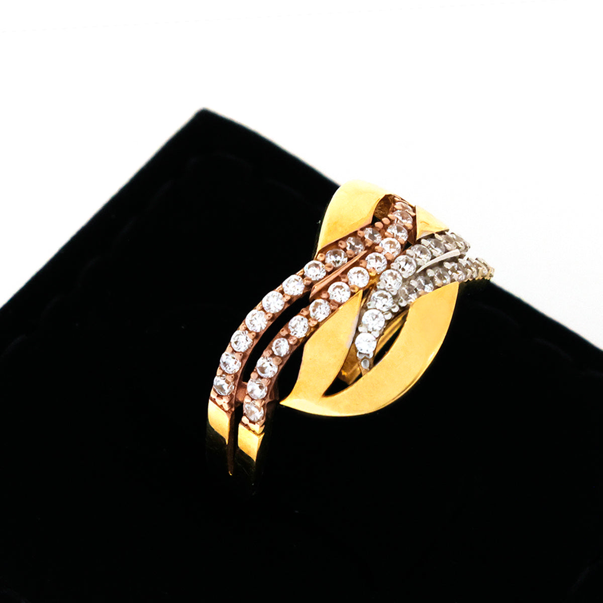 Gold ring with diamond accents on a black cushion