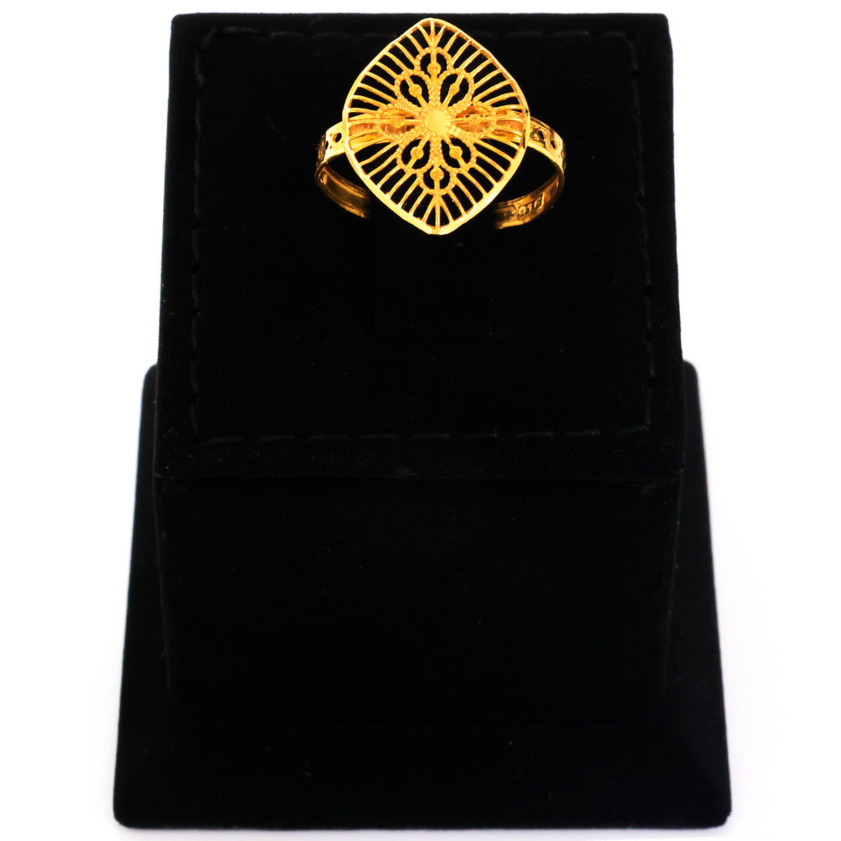 Gold ring with intricate design on a black velvet stand