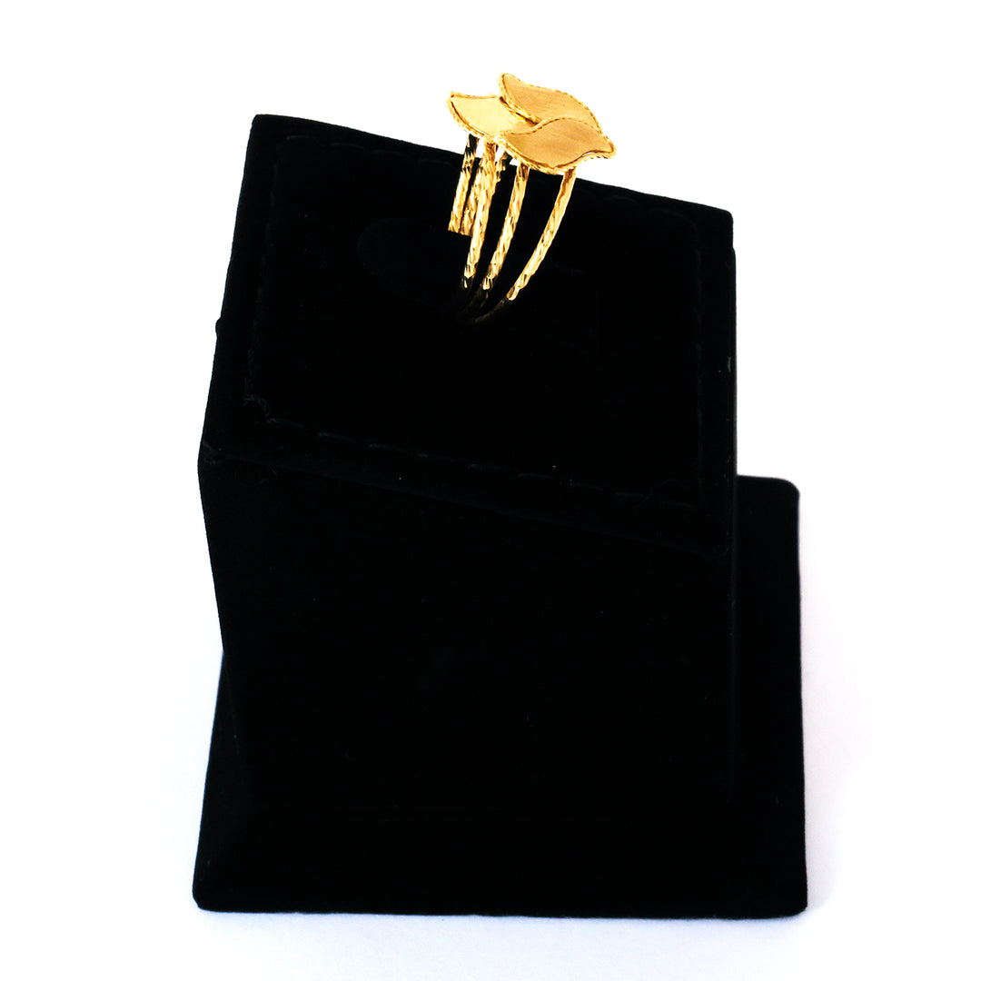Gold ring on a black velvet jewelry pouch against a white background