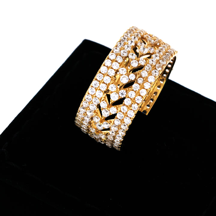Gold bracelet with clear stones on a black background