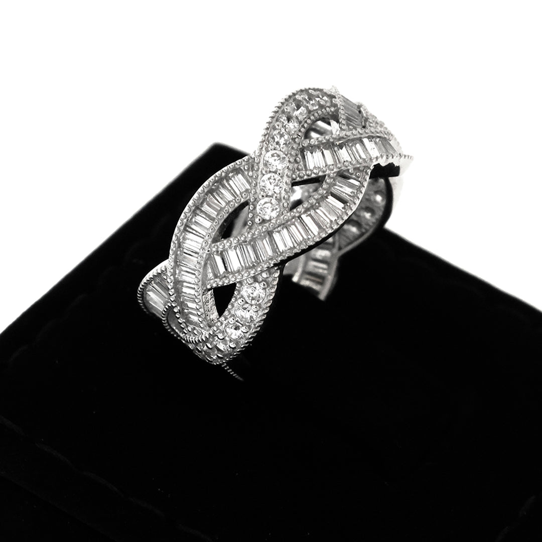 Silver bracelet with intricate design on a black velvet surface