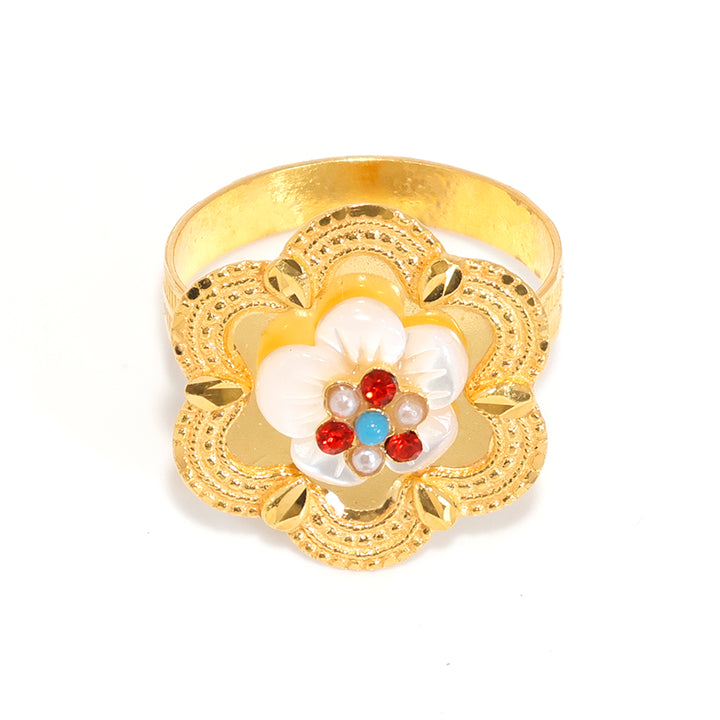 Gold ring with a floral design featuring pearls and red stones on a white background