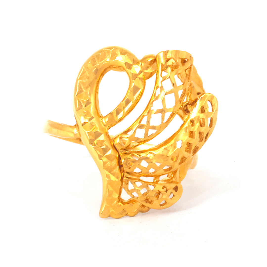 Gold ring with intricate design on a white background