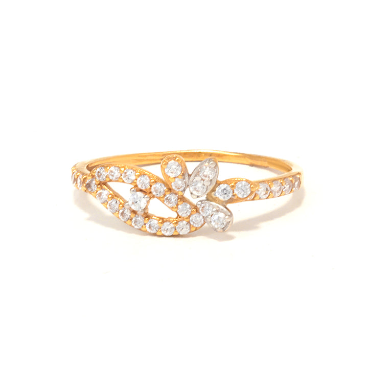 Gold ring with diamond accents on a white background