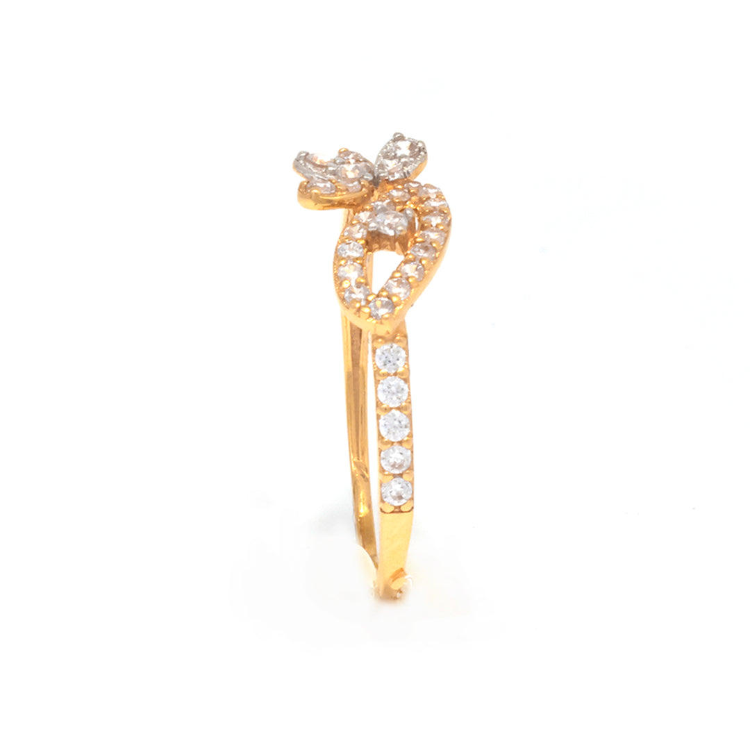 Gold ring with diamond accents on a white background