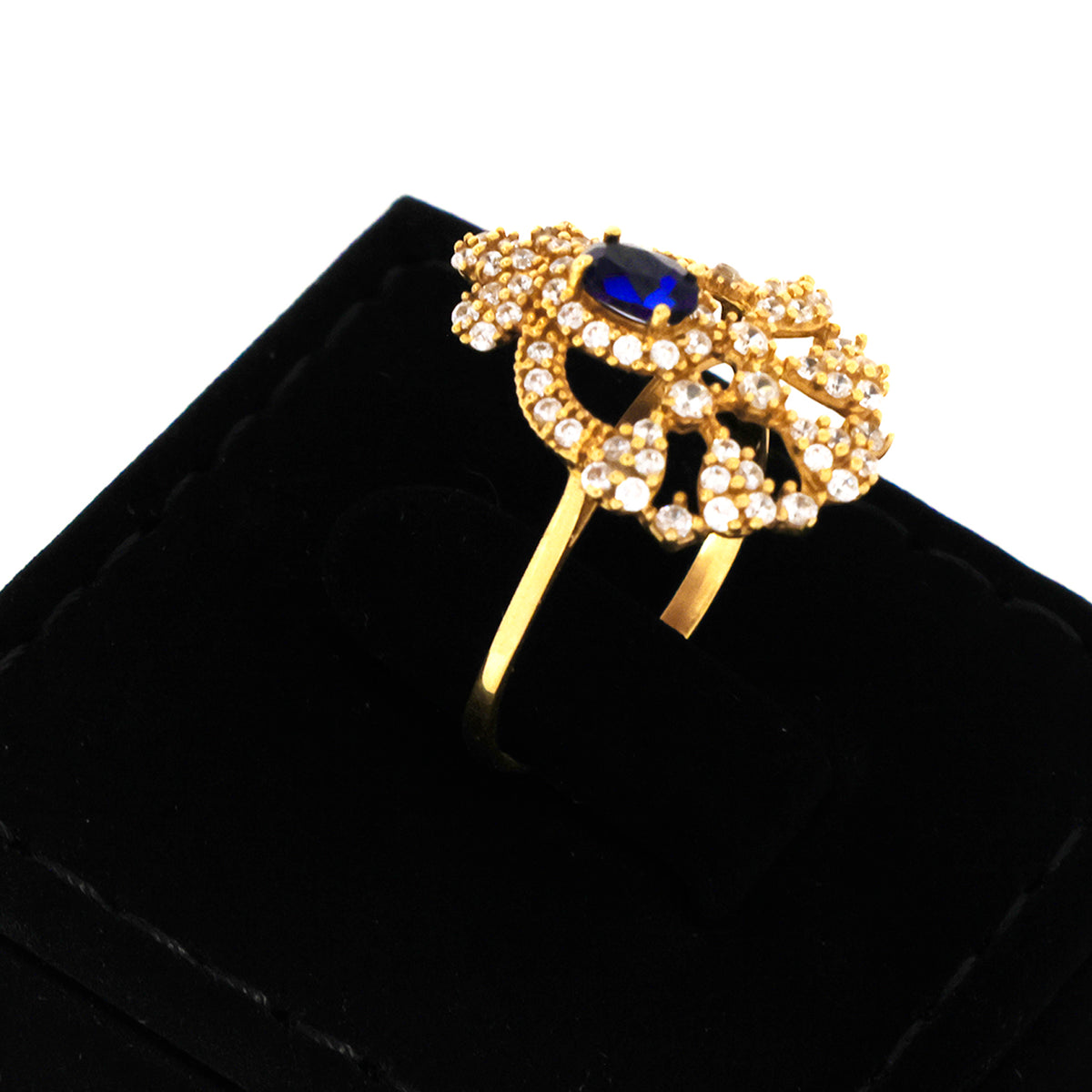 Gold brooch with a blue gemstone on a black background