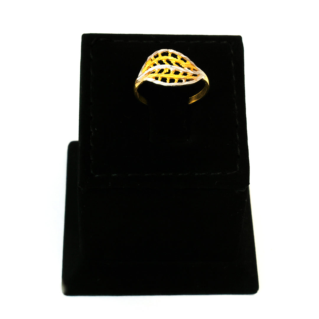 Gold ring on a black velvet stand with a white background