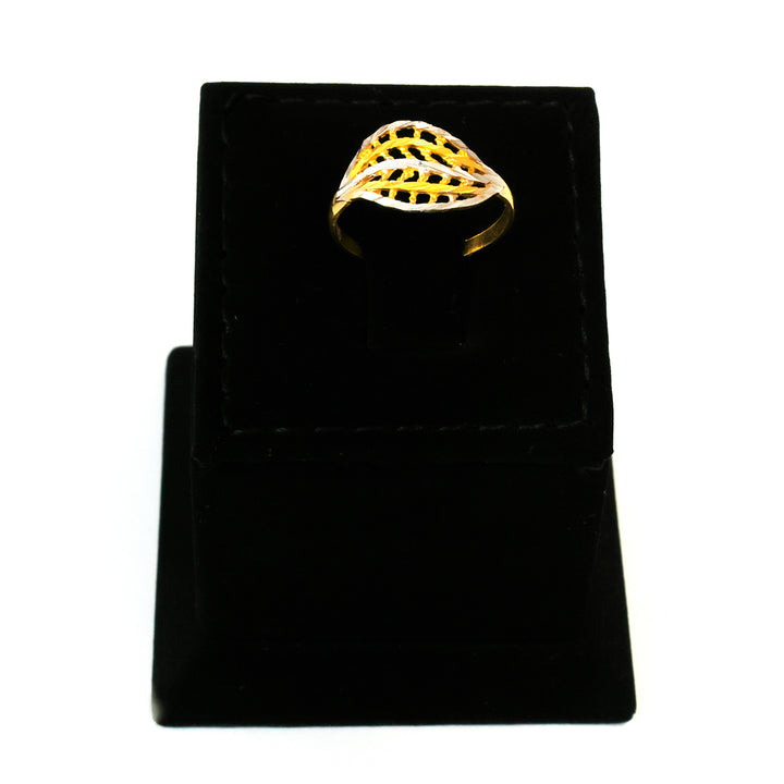 Gold ring on a black velvet stand with a white background