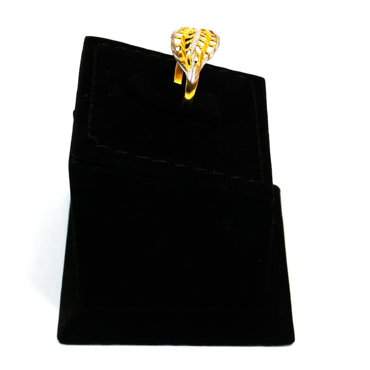 Gold ring on a black velvet jewelry pouch against a white background