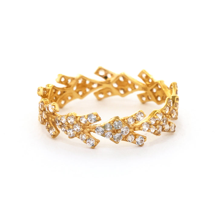 Gold bracelet with diamond-like stones on a white background