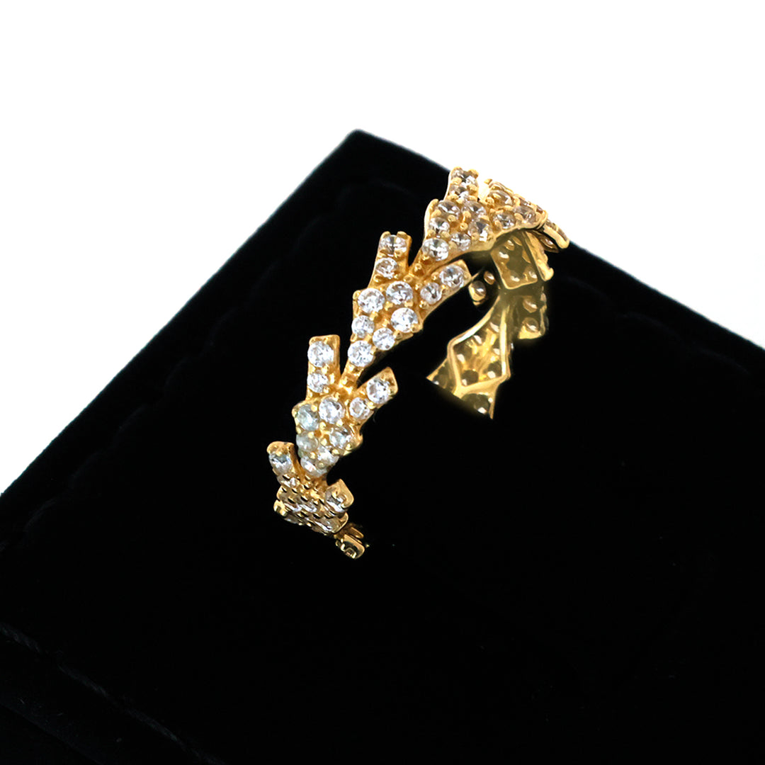 Gold and crystal decorative item on a black background