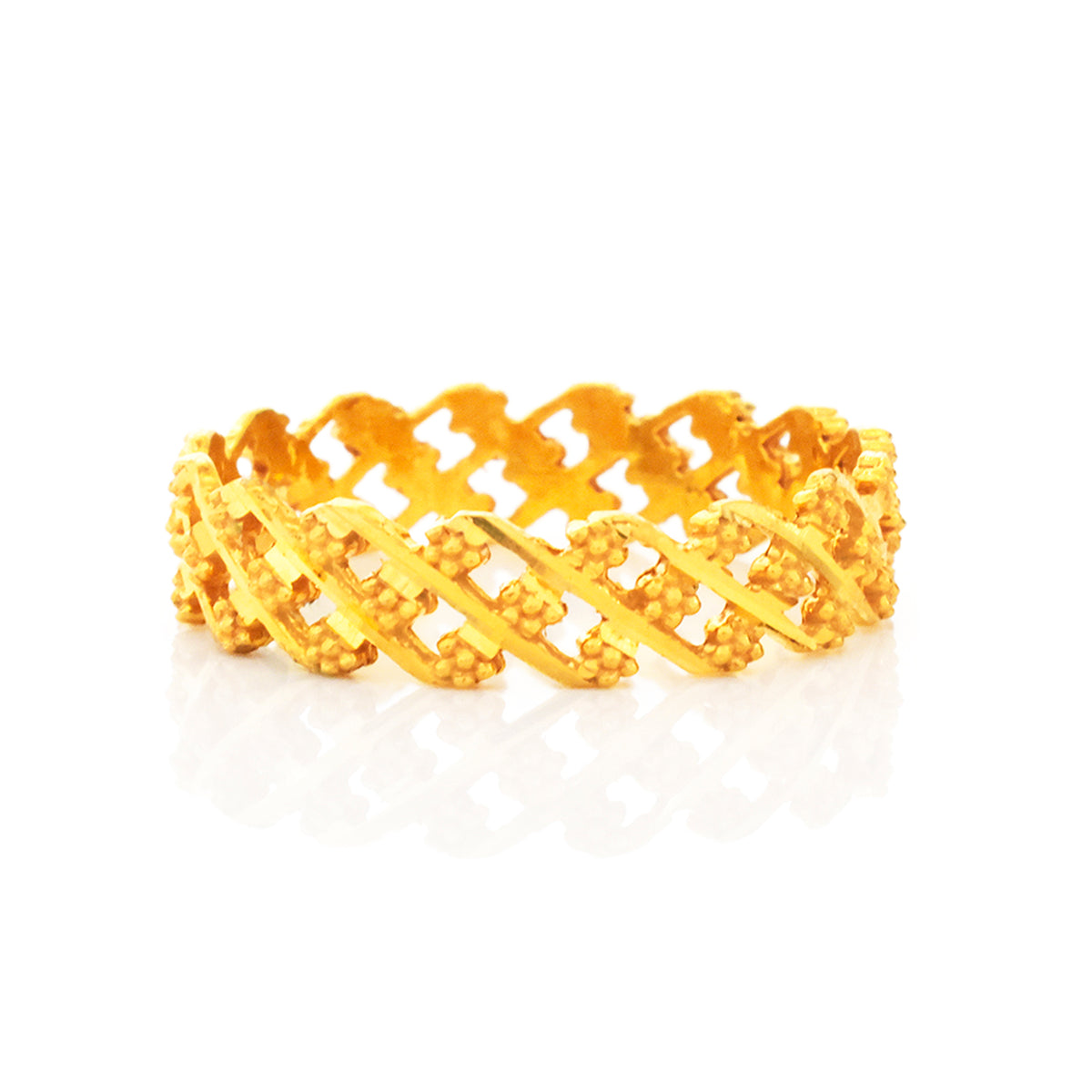 Gold ring with intricate design on a white background