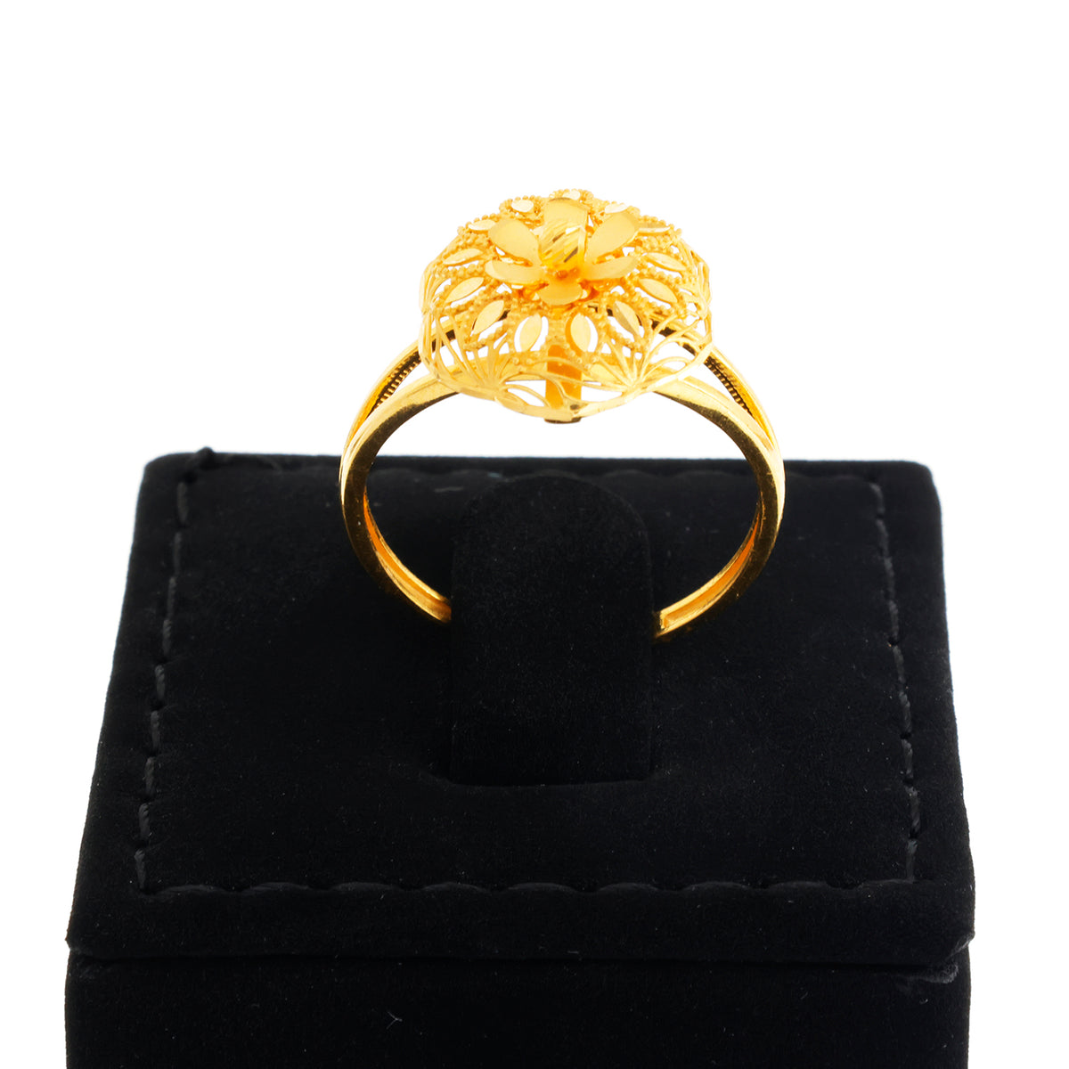 Gold ring on a black velvet stand with a white background