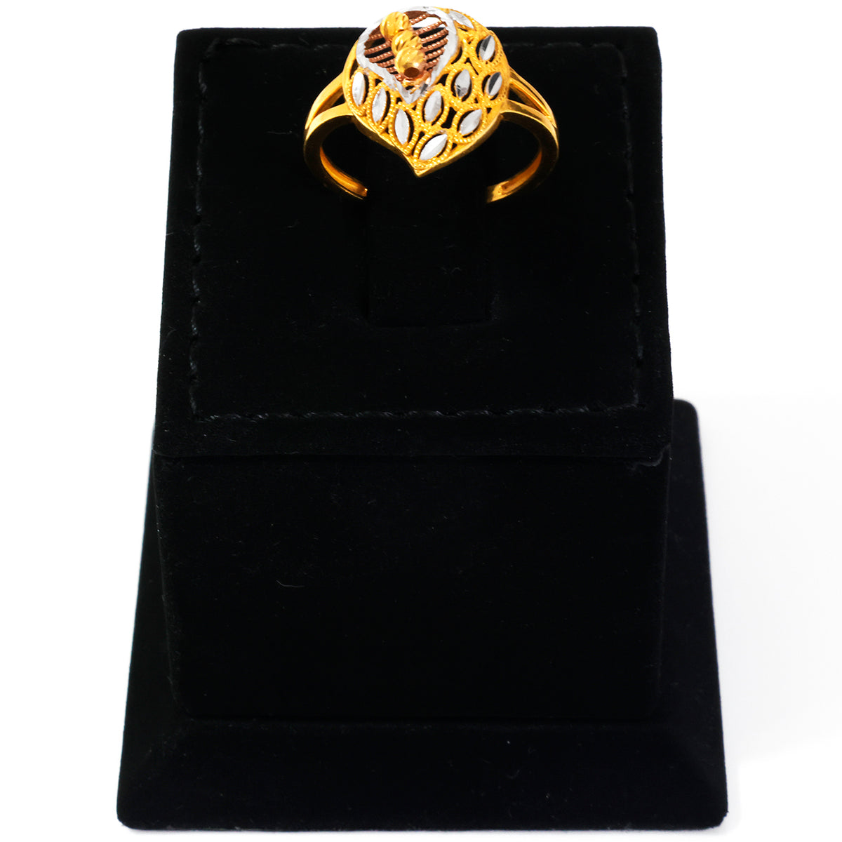 Gold ring with intricate design on a black velvet stand