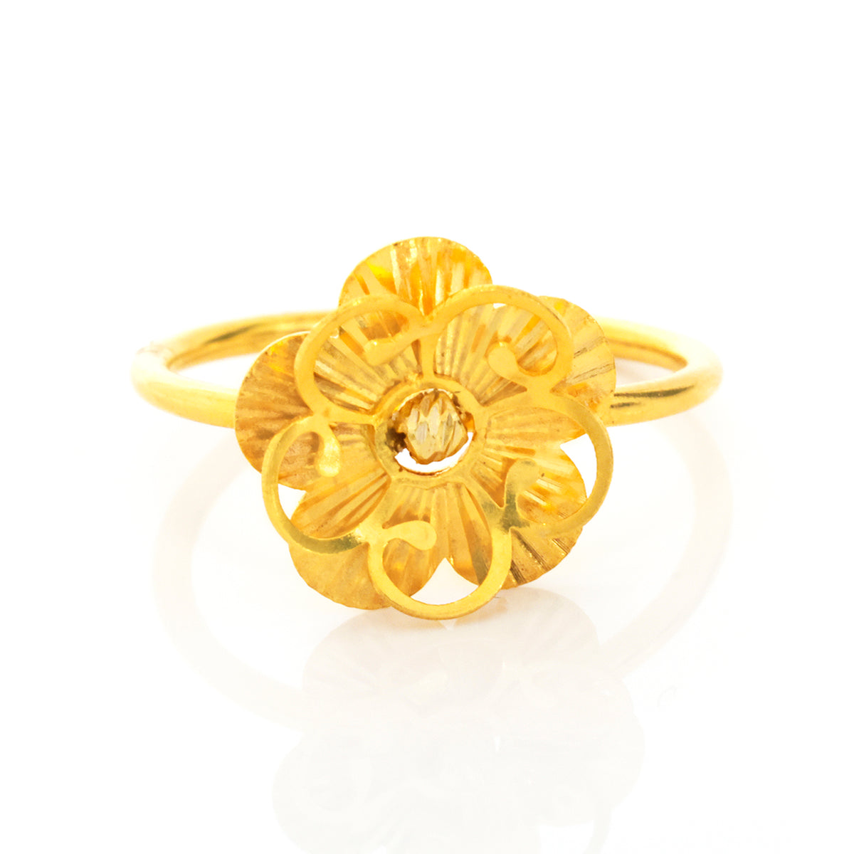 Gold ring with a floral design on a white background