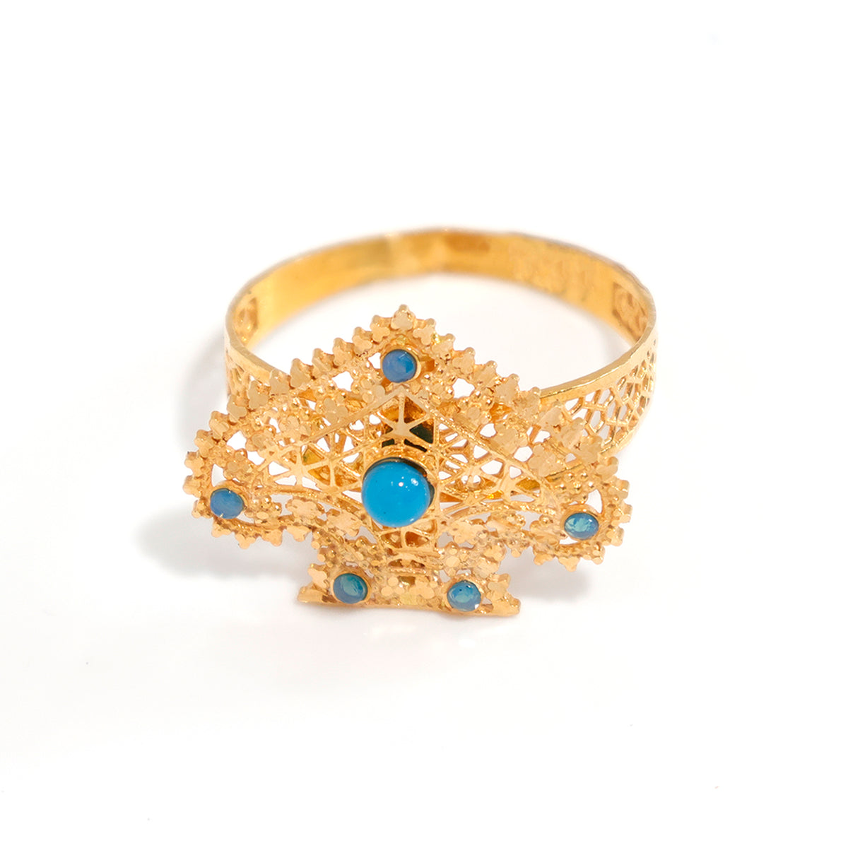Gold bracelet with blue gemstones on a white background