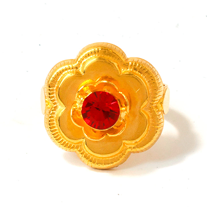 Gold flower-shaped earring with a red gemstone on a white background