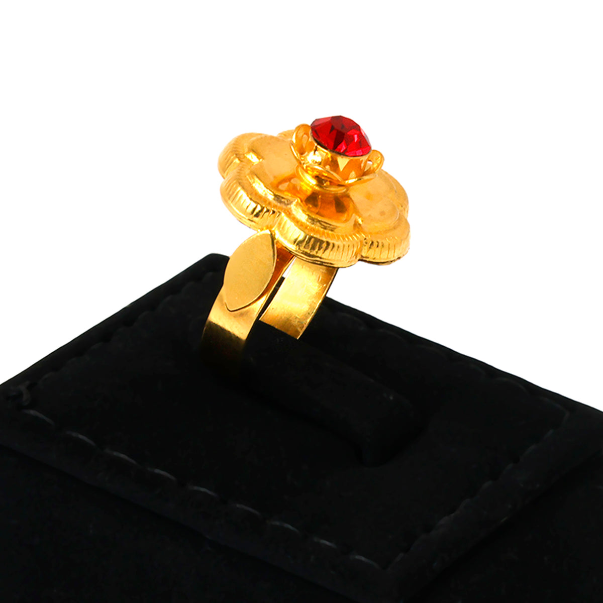 Gold ring with a red gemstone on a black velvet stand