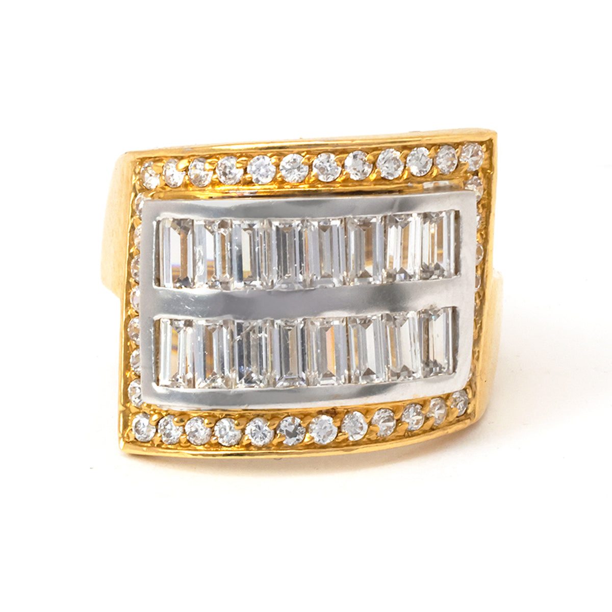 Gold and silver ring with baguette and round diamonds on a white background