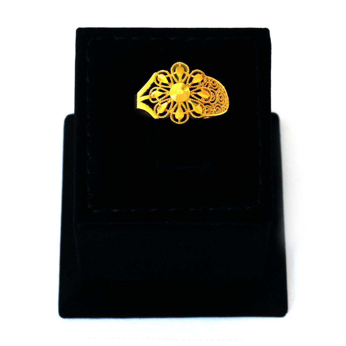 Gold brooch on a black velvet background
