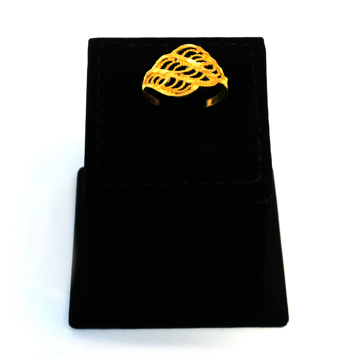 Gold ring on a black velvet stand with a white background