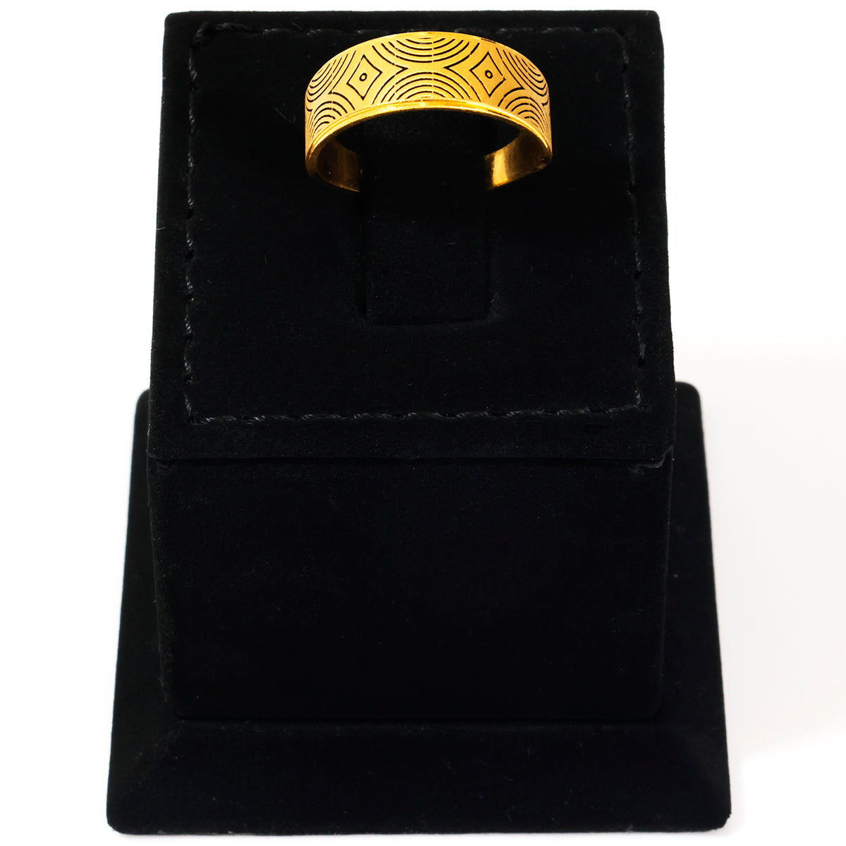 Gold ring with intricate design on a black velvet stand