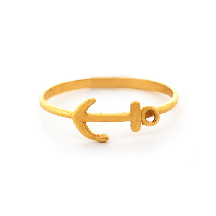 Gold anchor bracelet on a white background