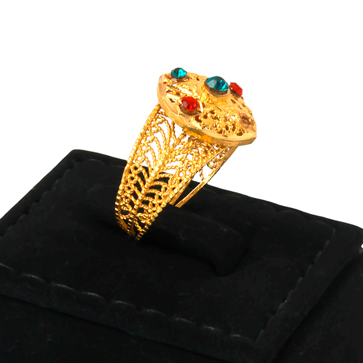Gold ring with gemstones on a black cushion