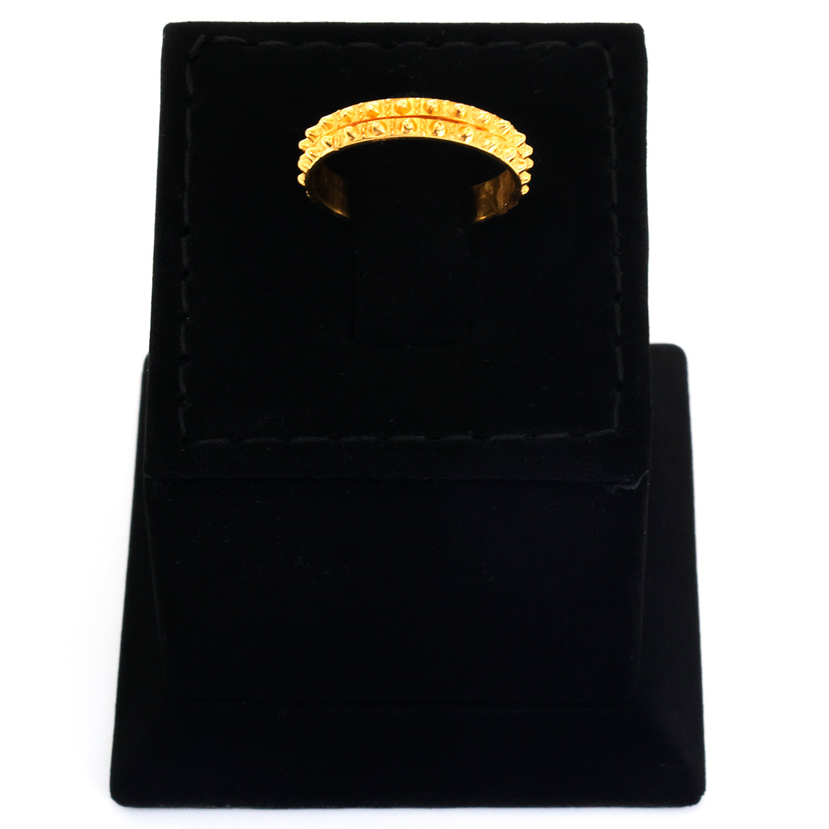 Gold ring in a black velvet box on a white background