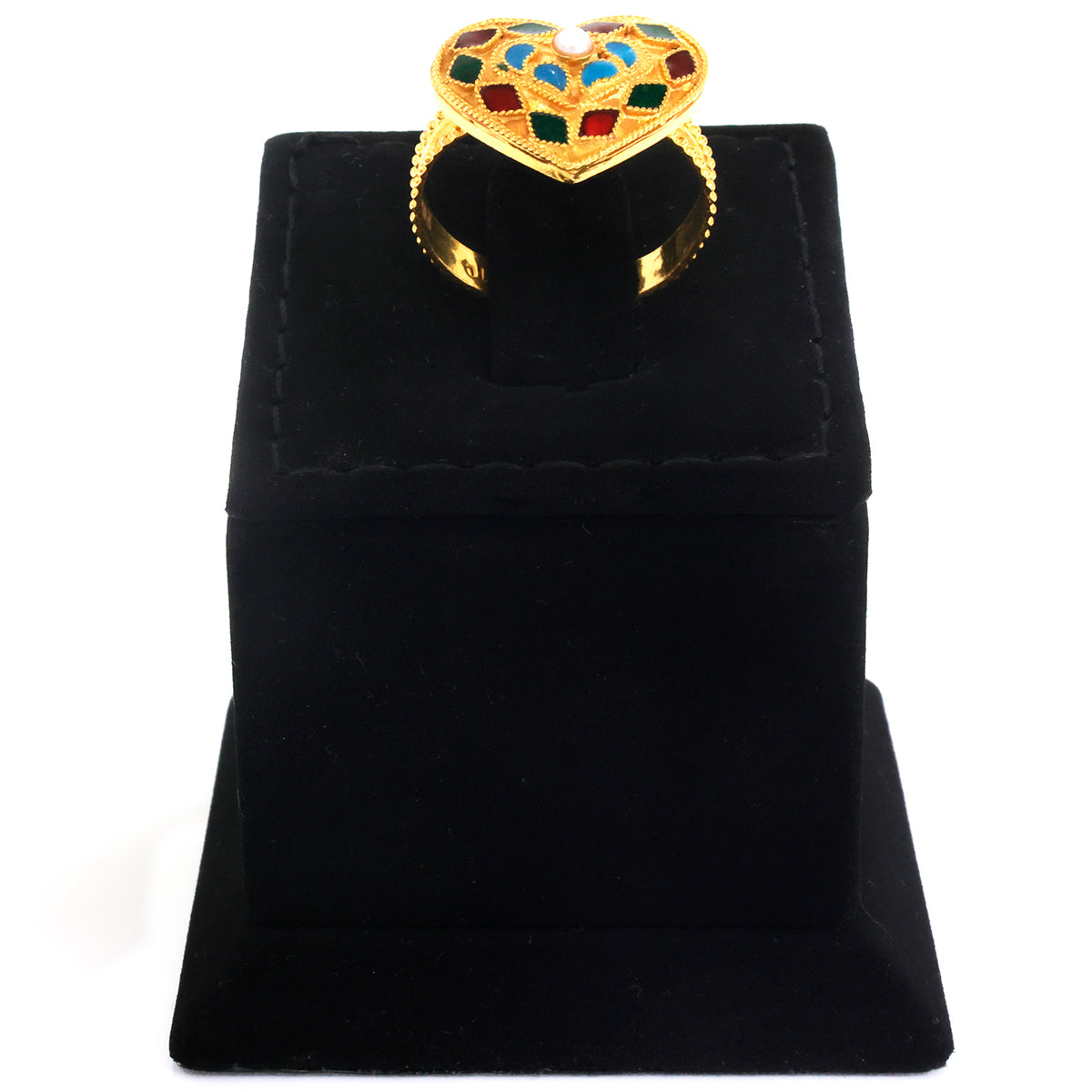 A gold heart-shaped ring with colorful enamel details in blue, green, and red, displayed on a black velvet jewelry box against a white background.