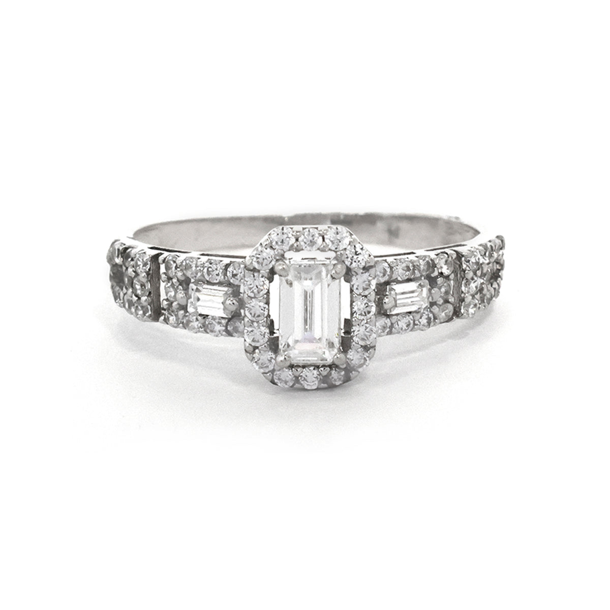 Diamond ring with a central emerald-cut diamond and smaller baguette diamonds on a white background