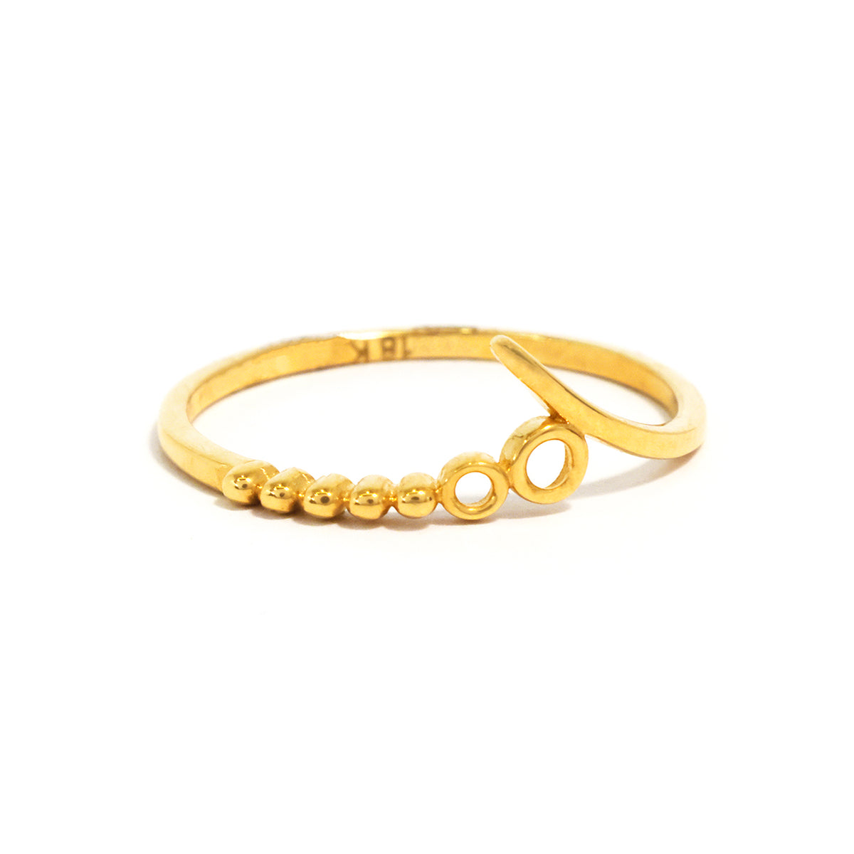 Gold ring with circular and bead designs on a white background