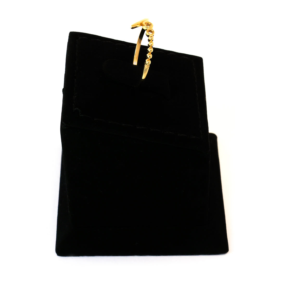 Black jewelry pouch with a gold clasp on a white background