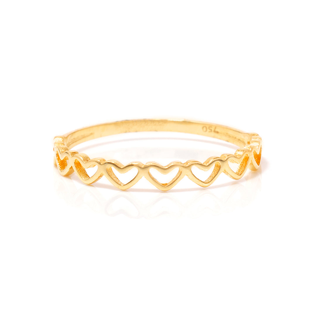 Gold ring with heart designs on a white background