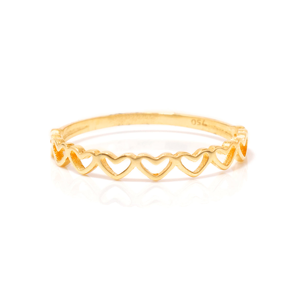 Gold ring with heart designs on a white background