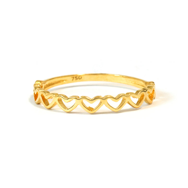 Gold ring with heart designs on a white background