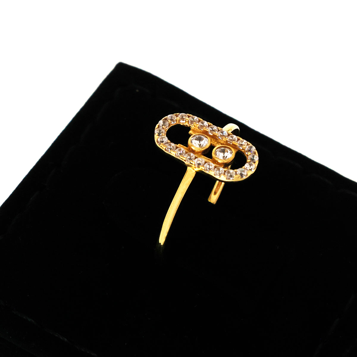 Gold brooch with gemstones on a black velvet background