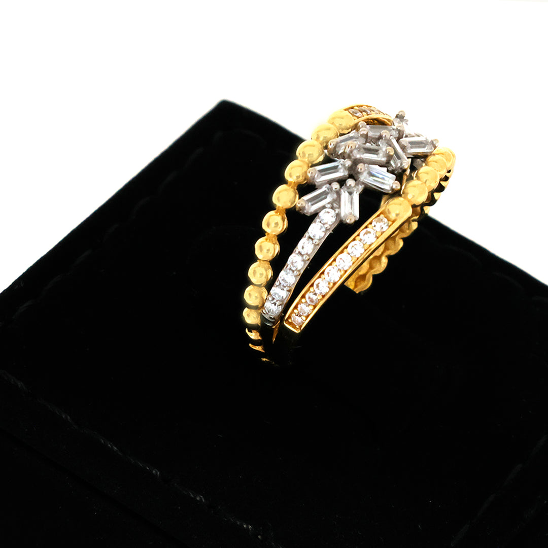 Gold and silver ring with diamond accents on a black velvet stand